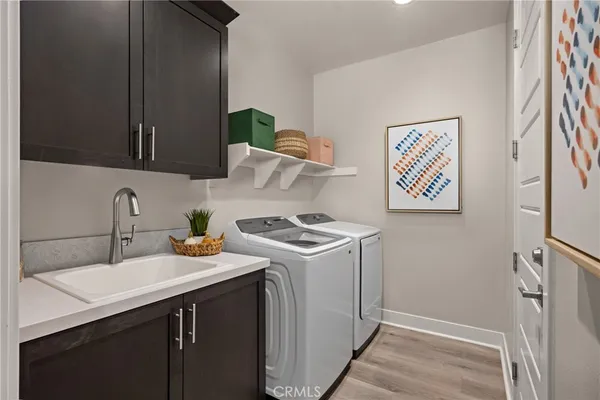 a kitchen with a sink a stove and cabinets