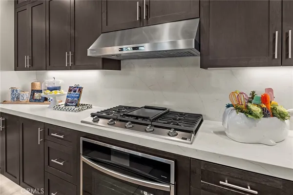 a kitchen with a stove and cabinets