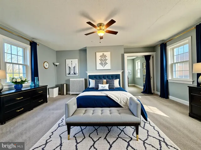 a large bedroom with a large bed and a chandelier