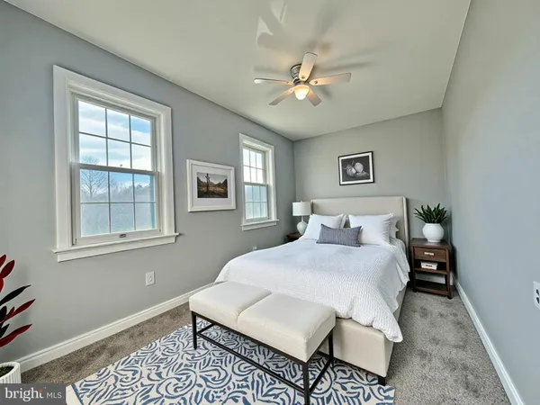 a bedroom with a bed rug and window