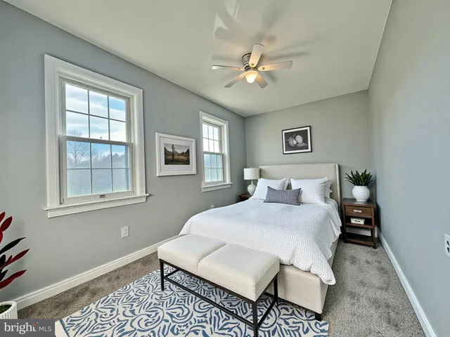 a bedroom with a bed rug and window