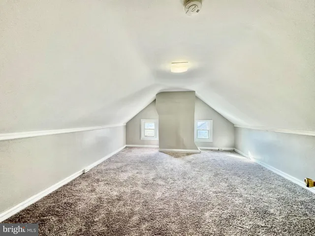 a view of a big room with closet and windows