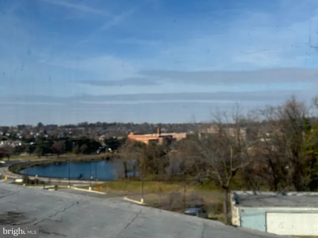 a view of a balcony with yard & street