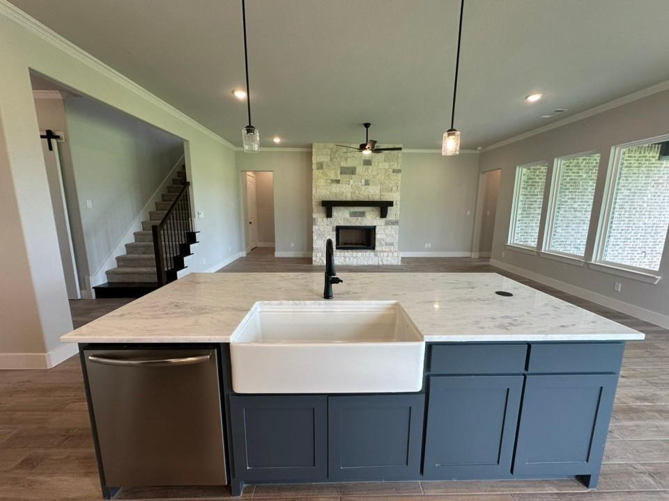390 Cobb Road Leonard, TX 75452 - Photo 15 of 26 Kitchen island featuring a farmhouse sink, stainless steel dishwasher, and quartz countertop