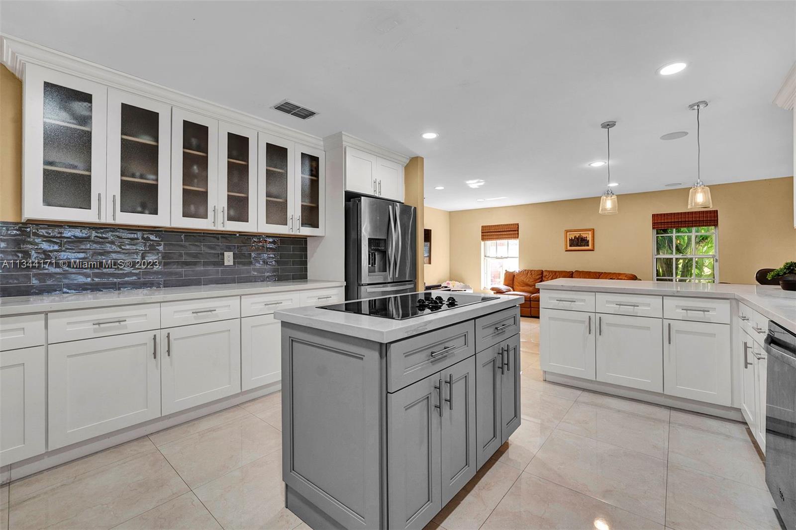 20100 Red Run Drive Hialeah, FL 33015 - Photo 12 of 61 a kitchen with granite countertop a sink stove and cabinets