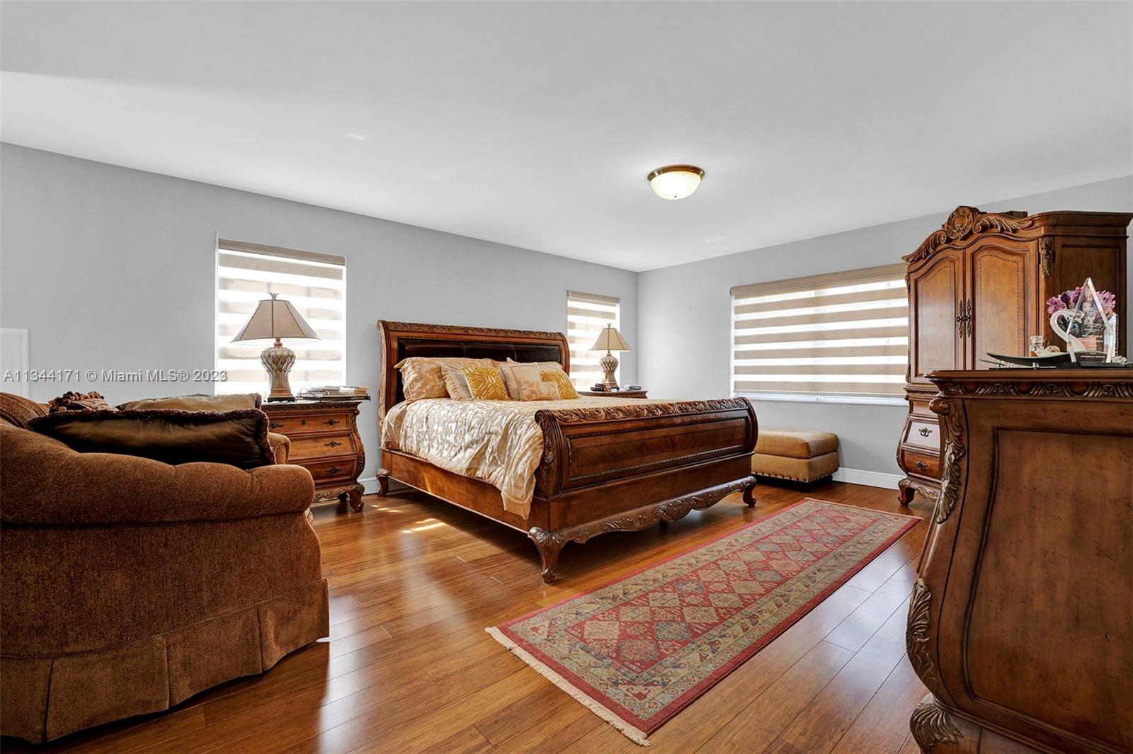 20100 Red Run Drive Hialeah, FL 33015 - Photo 13 of 61 a bedroom with a bed and wooden floor