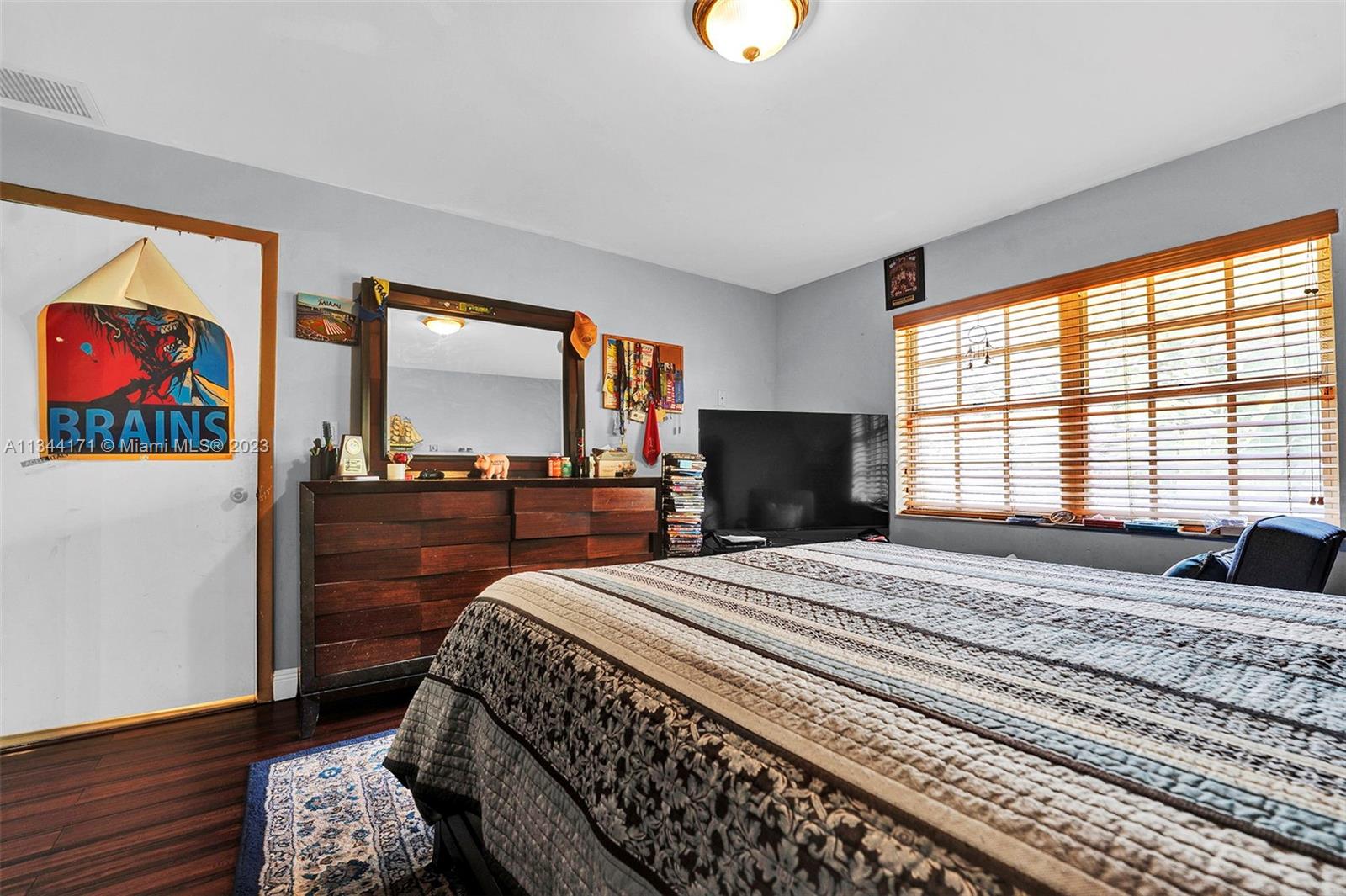 20100 Red Run Drive Hialeah, FL 33015 - Photo 19 of 61 a bedroom with a bed and a large window