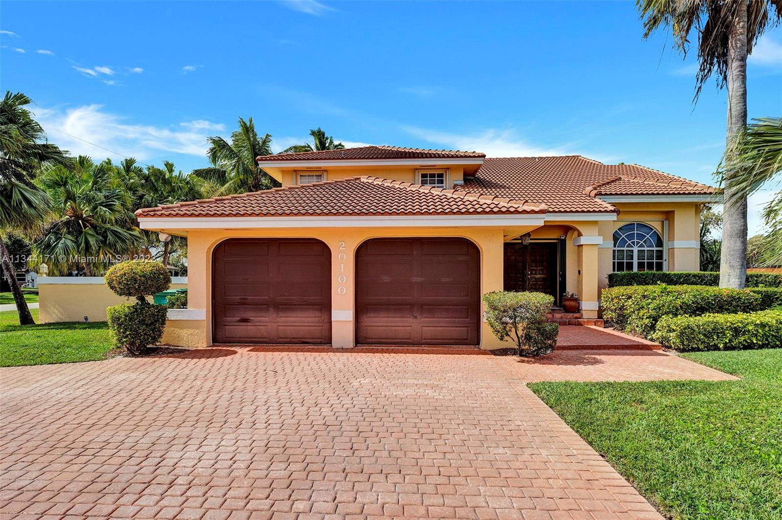 20100 Red Run Drive Hialeah, FL 33015 - Photo 2 of 61 a front view of a house with a yard and garage