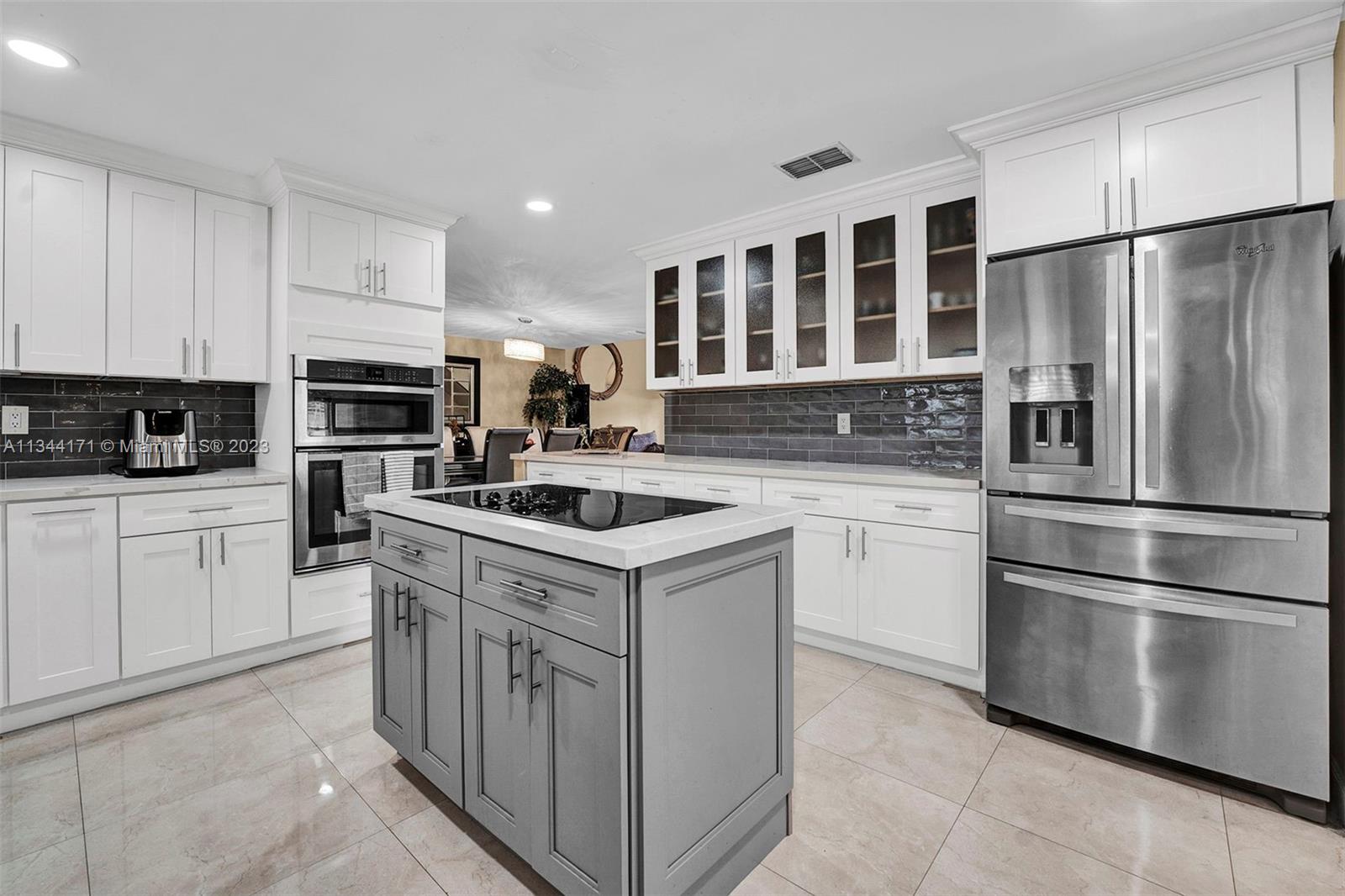 20100 Red Run Drive Hialeah, FL 33015 - Photo 8 of 61 a kitchen with white cabinets stainless steel appliances and sink