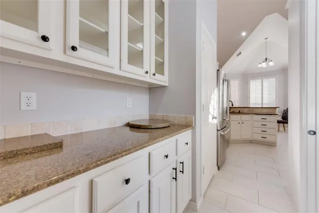 a kitchen with granite countertop a sink and a stove
