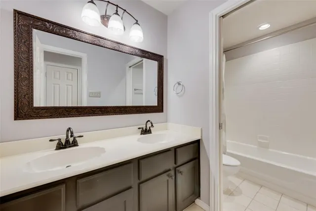 a bathroom with a double vanity sink mirror and