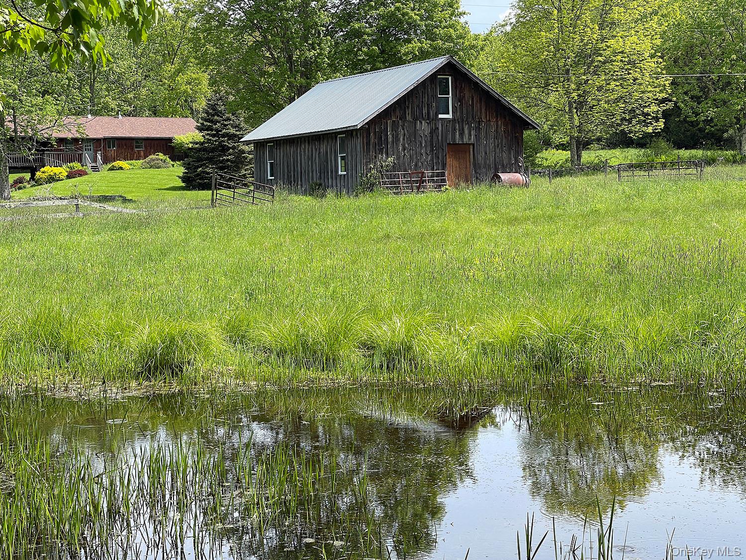 Menges Road Livingston Manor, NY 12791 - Photo 27 of 32 a backyard of a house with a garden and outdoor seating