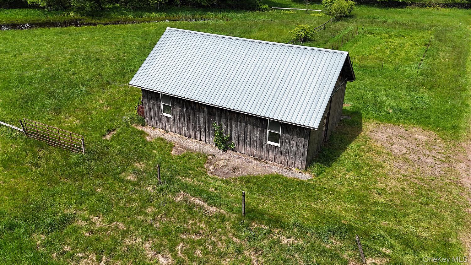 Menges Road Livingston Manor, NY 12791 - Photo 28 of 32 a view of a backyard with barn plants and large trees