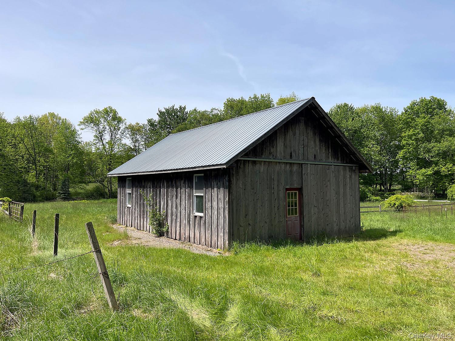 Menges Road Livingston Manor, NY 12791 - Photo 31 of 32 a backyard of a house with lots of green space and wooden fence
