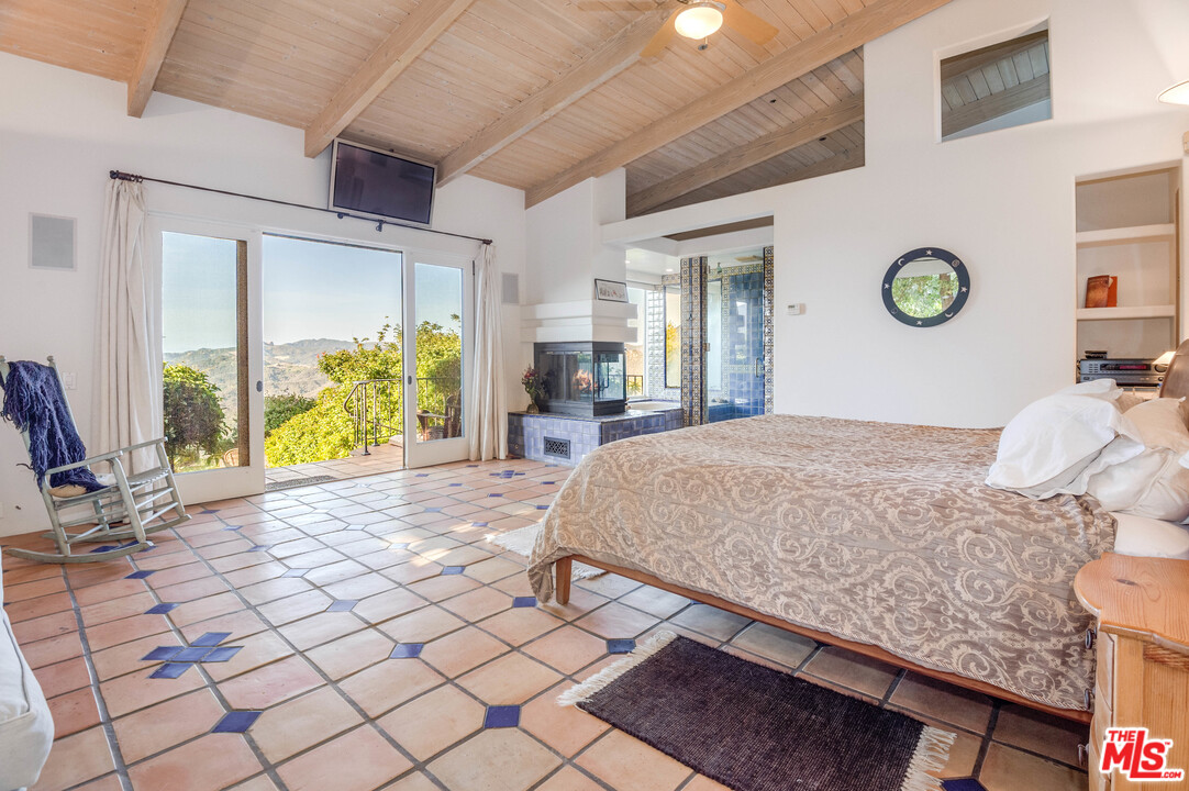 20333 Reigate Road Topanga, CA 90290 - Photo 7 of 21 a bedroom with a bed and window