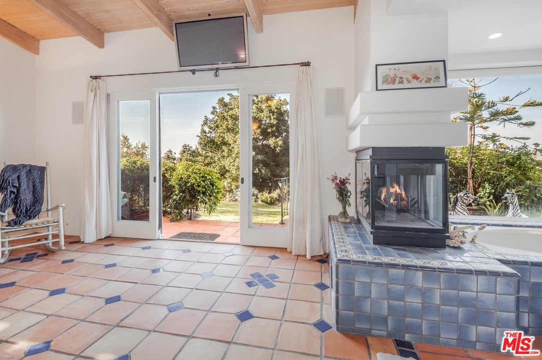 20333 Reigate Road Topanga, CA 90290 - Photo 8 of 21 a living room with furniture and a fireplace