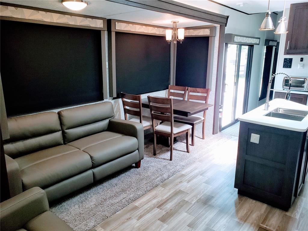 3000 Clarcona Road, Unit 2710 Apopka, FL 32703 - Photo 11 of 30 a living room with furniture and a flat screen tv