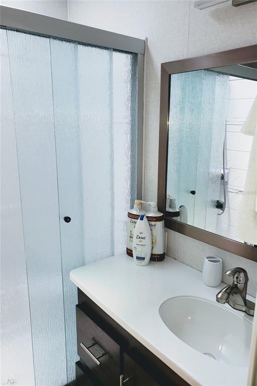 3000 Clarcona Road, Unit 2710 Apopka, FL 32703 - Photo 16 of 30 a bathroom with a sink and a mirror