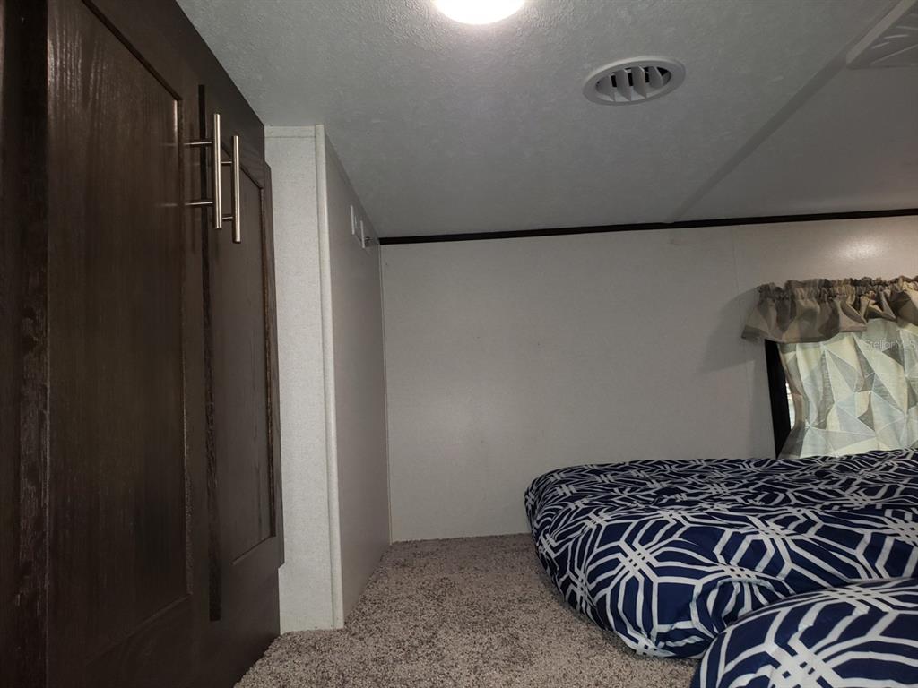 3000 Clarcona Road, Unit 2710 Apopka, FL 32703 - Photo 21 of 30 a bedroom with a bed and a wall painting