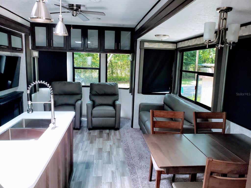 3000 Clarcona Road, Unit 2710 Apopka, FL 32703 - Photo 8 of 30 a living room with furniture and a flat screen tv