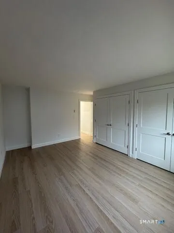 a view of an empty room and wooden floor