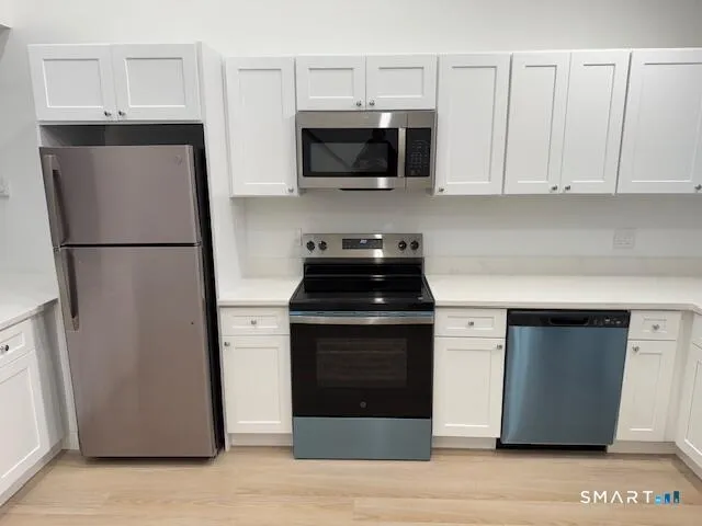 a kitchen with a refrigerator and a stove