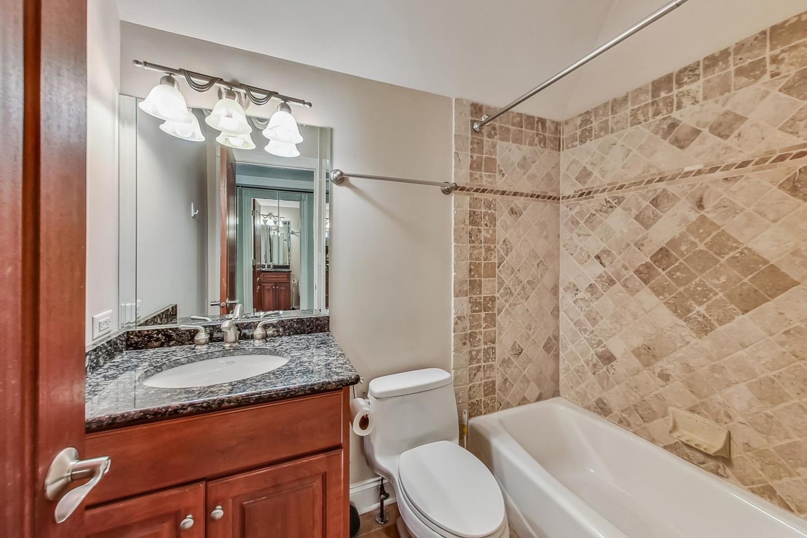 105 Fuller Road Hinsdale, IL 60521 - Photo 41 of 57 a bathroom with a granite countertop sink toilet and shower