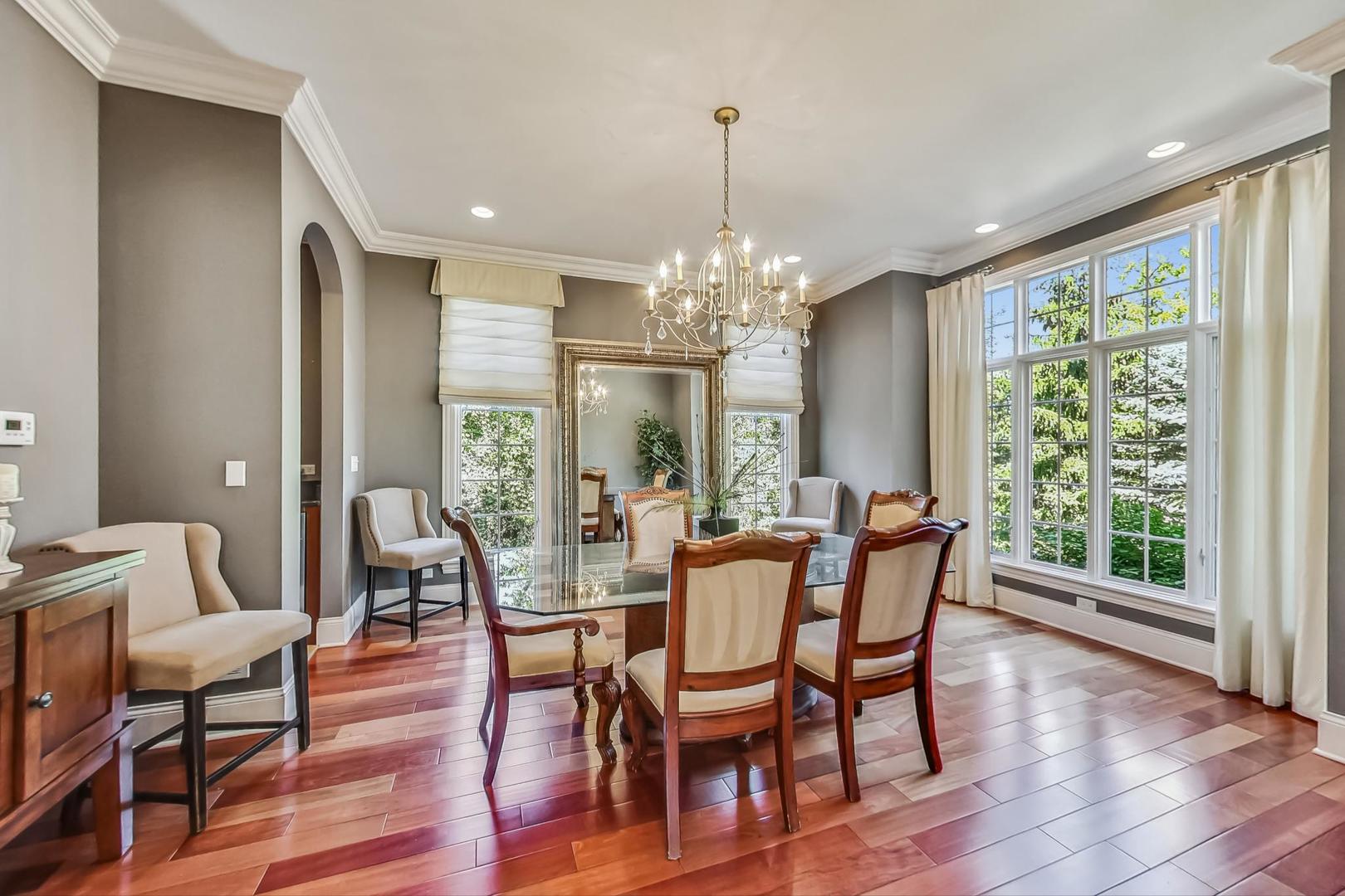 105 Fuller Road Hinsdale, IL 60521 - Photo 8 of 57 a view of a dining room with furniture window and wooden floor