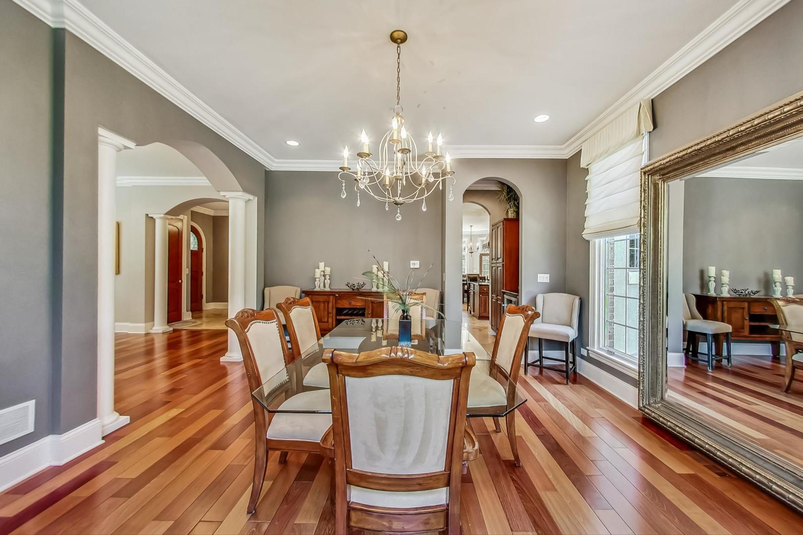 105 Fuller Road Hinsdale, IL 60521 - Photo 9 of 57 a view of a dining room with furniture a chandelier and wooden floor