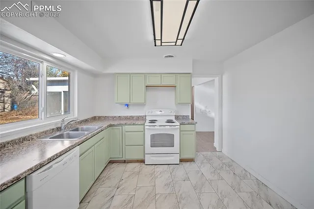 a kitchen with a sink stove and cabinets