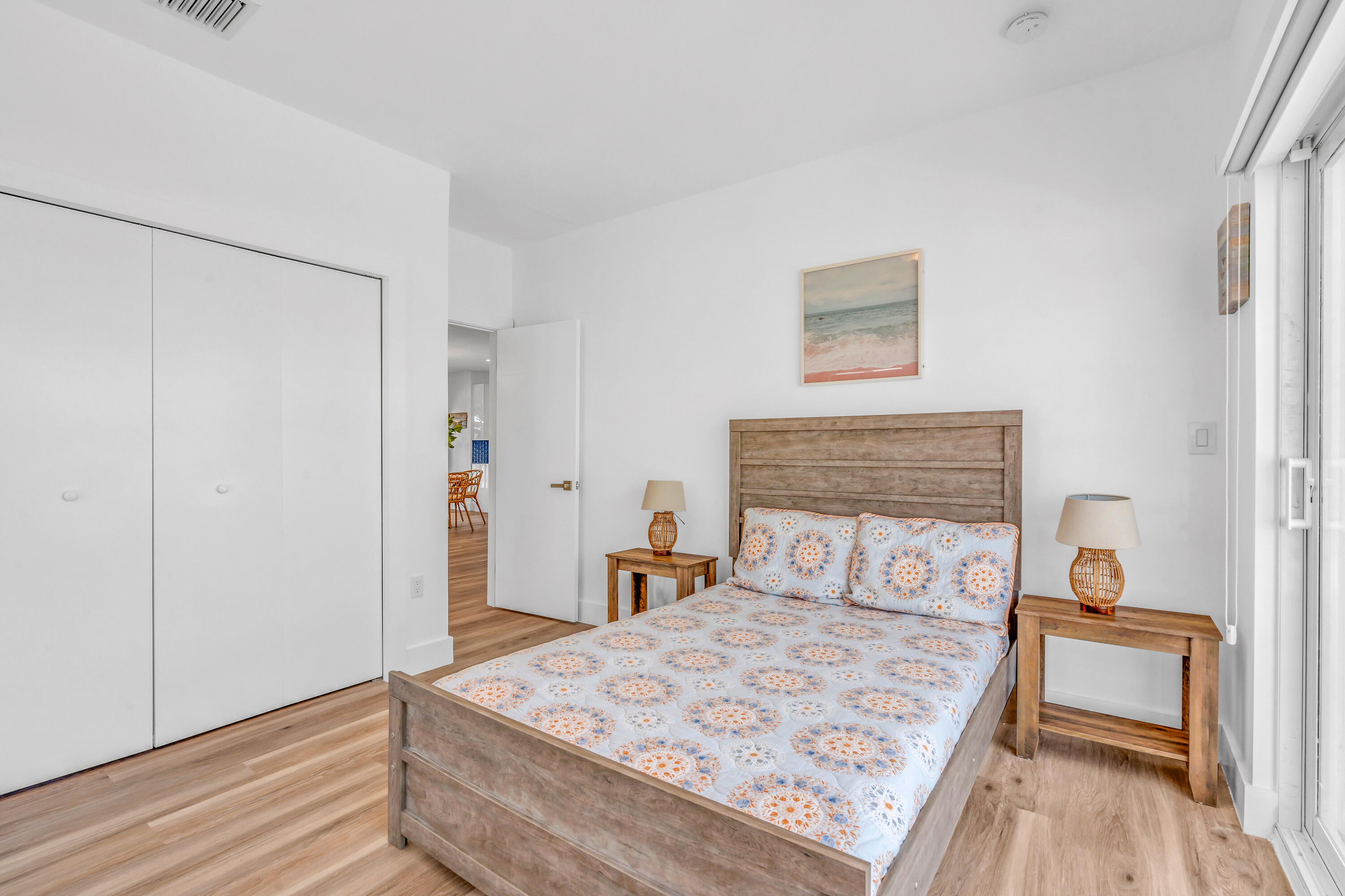 229 Upper Matecumbe Road Key Largo, FL 33037 - Photo 27 of 77 a bedroom with a bed and wooden floor