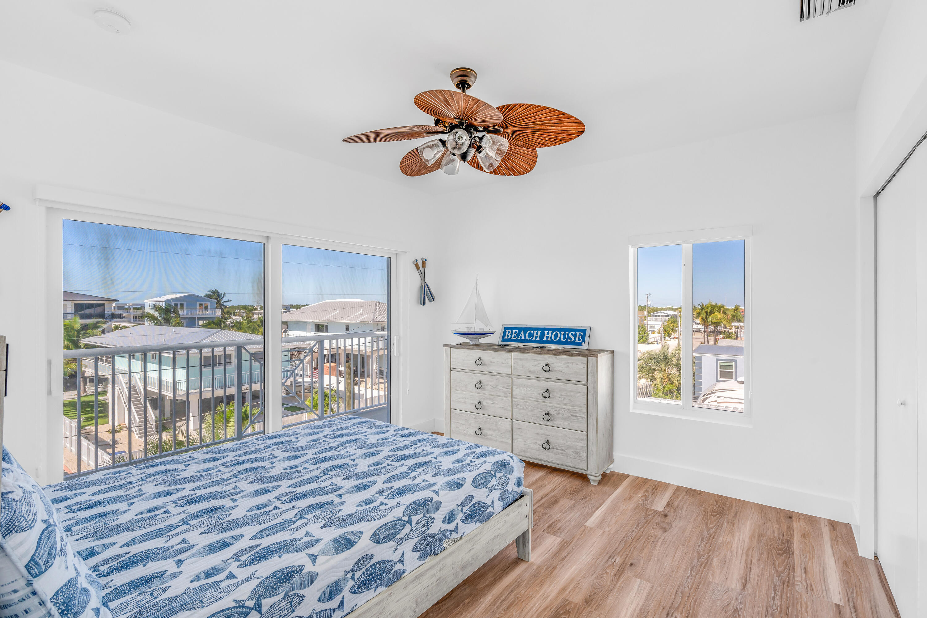 229 Upper Matecumbe Road Key Largo, FL 33037 - Photo 29 of 77 a bedroom with a bed and a dresser