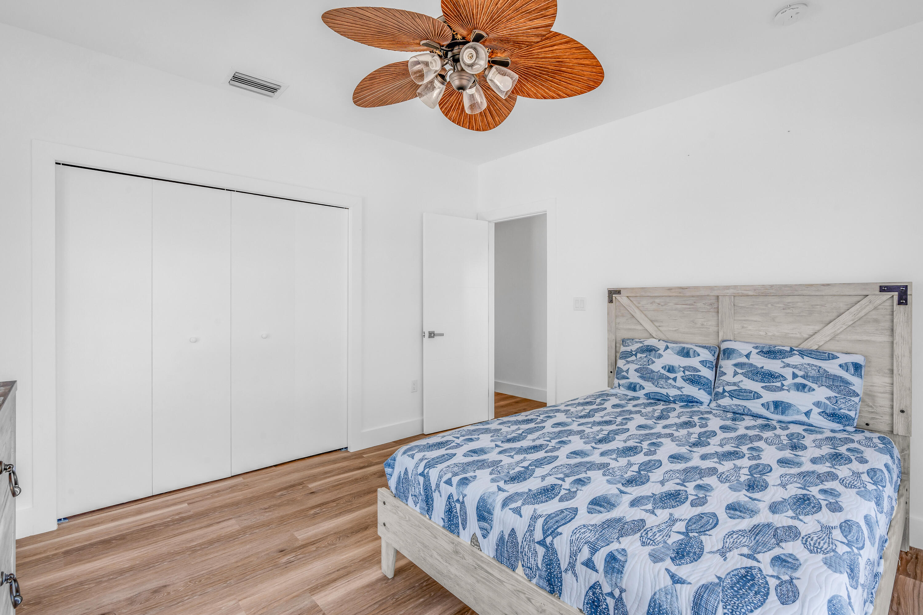 229 Upper Matecumbe Road Key Largo, FL 33037 - Photo 30 of 77 a bedroom with a bed and a chandelier