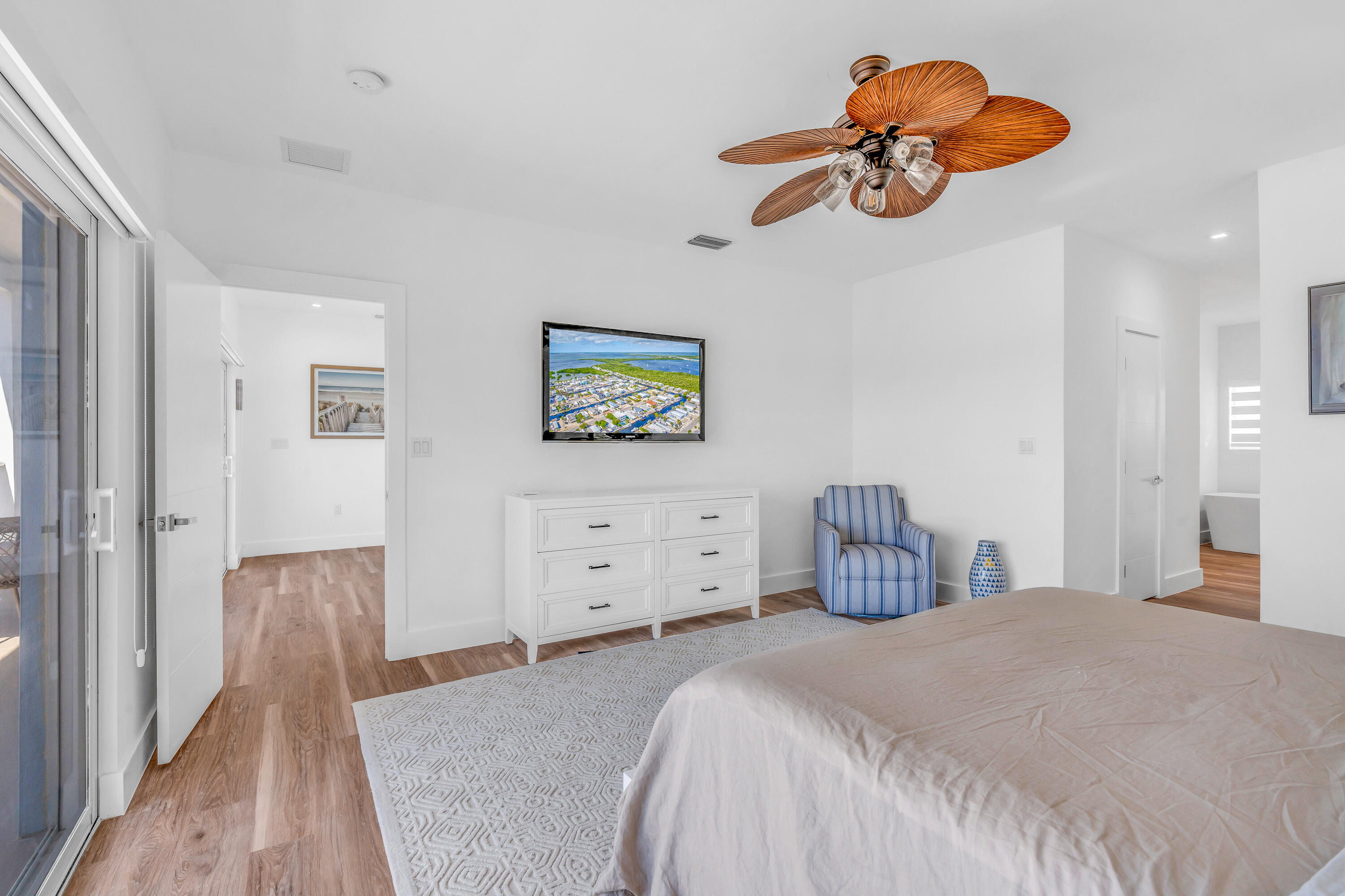 229 Upper Matecumbe Road Key Largo, FL 33037 - Photo 41 of 77 a bedroom with a bed and a chandelier