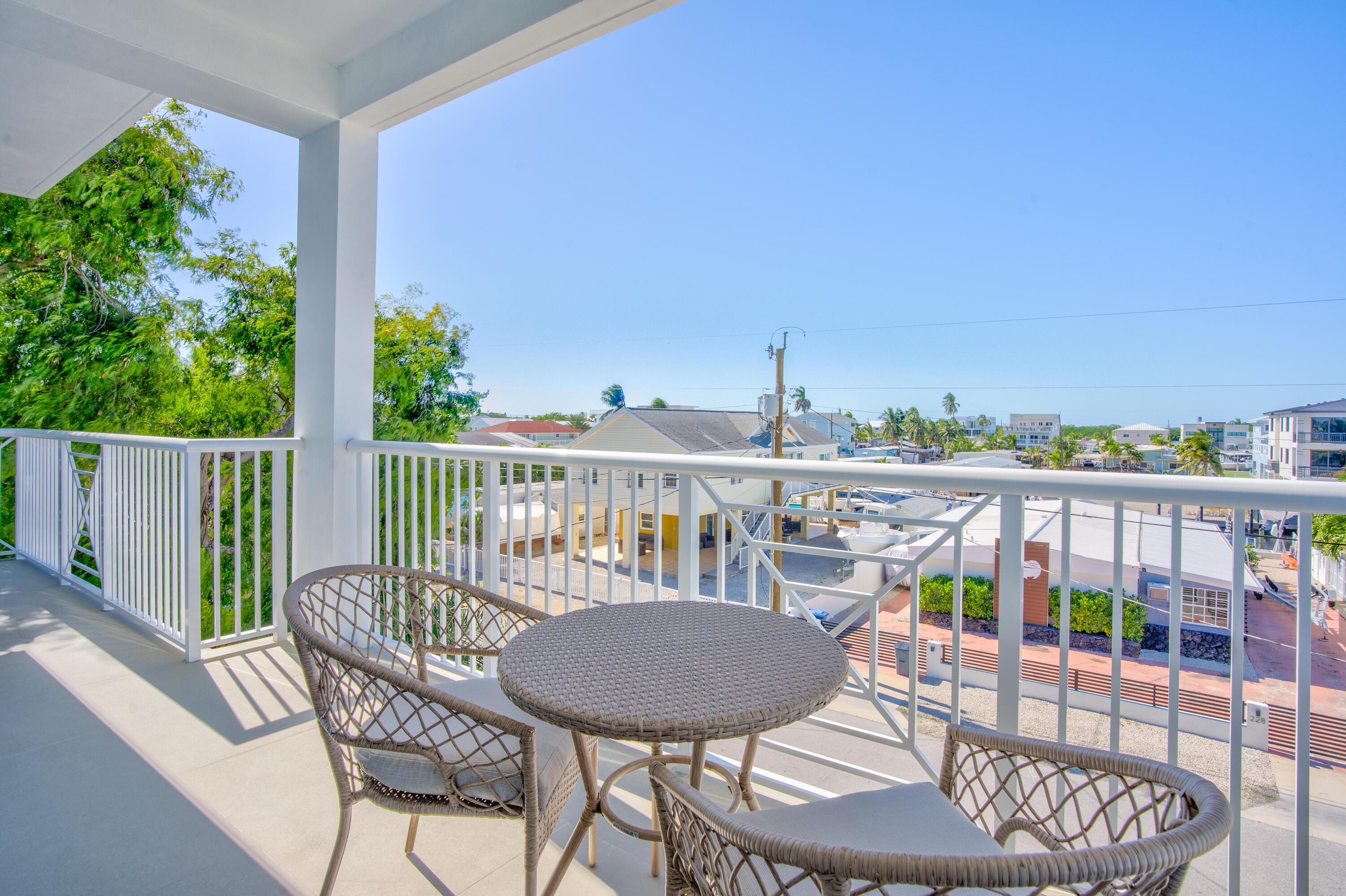 229 Upper Matecumbe Road Key Largo, FL 33037 - Photo 55 of 77 a view of a balcony with a table and chairs with wooden floor