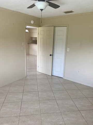 a view of an empty room with a bathroom