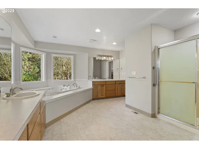 a bathroom with a tub sink and mirror