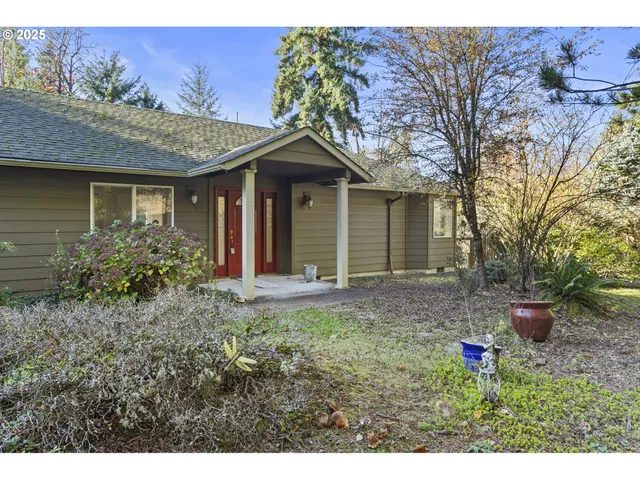 a view of a house with yard and a garden