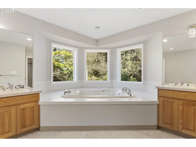 a bathroom with a sink mirror and a bathtub