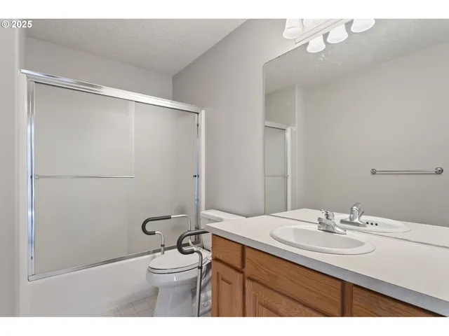 a kitchen with granite countertop white cabinets and stainless steel appliances