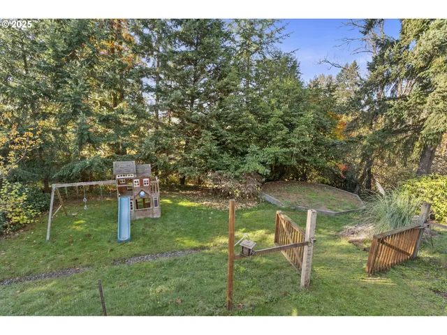 a backyard of a house with table and chairs