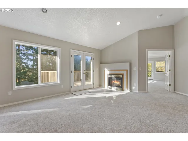 a big room with windows and a fireplace