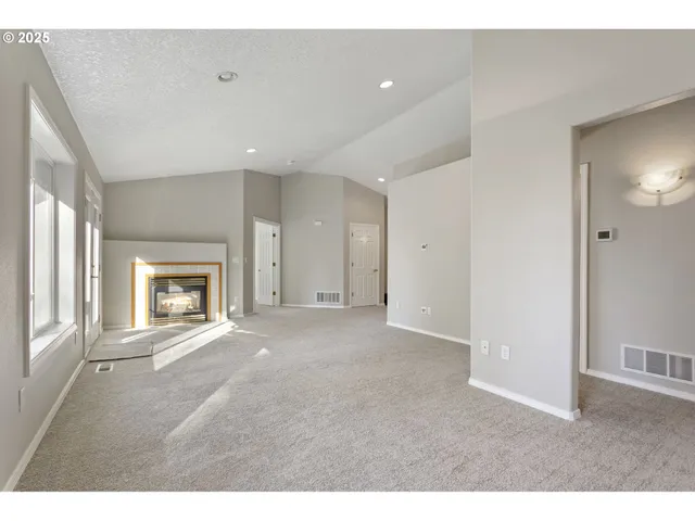 a view of an empty room and a fireplace