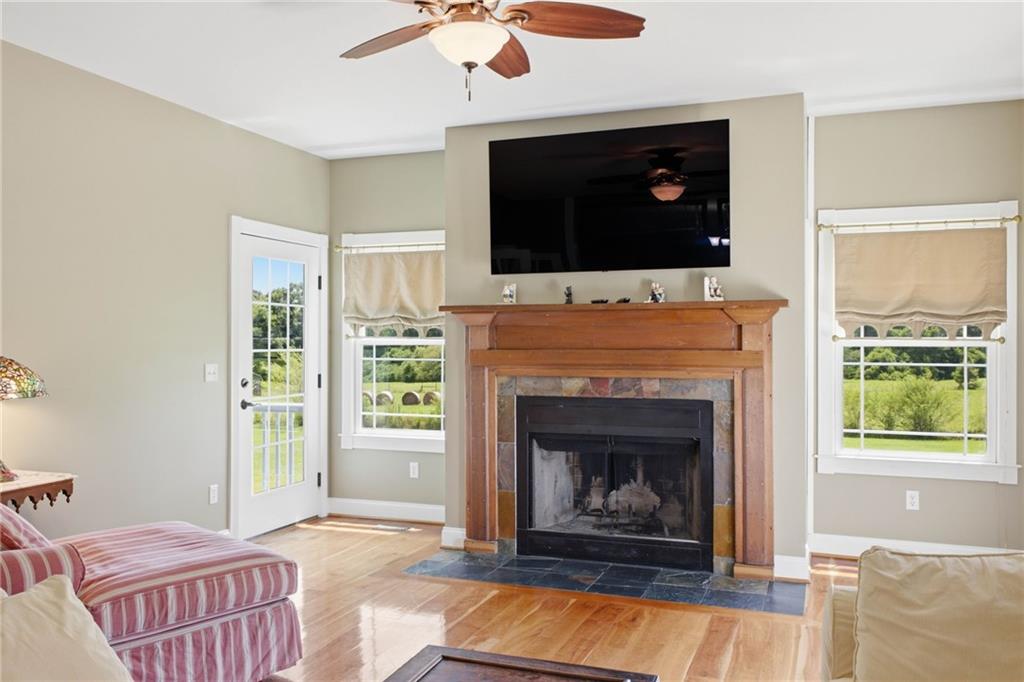 6729 Big Texas Valley Road Northwest Rome, GA 30165 - Photo 40 of 95 a living room with a fireplace a flat screen tv and a fireplace