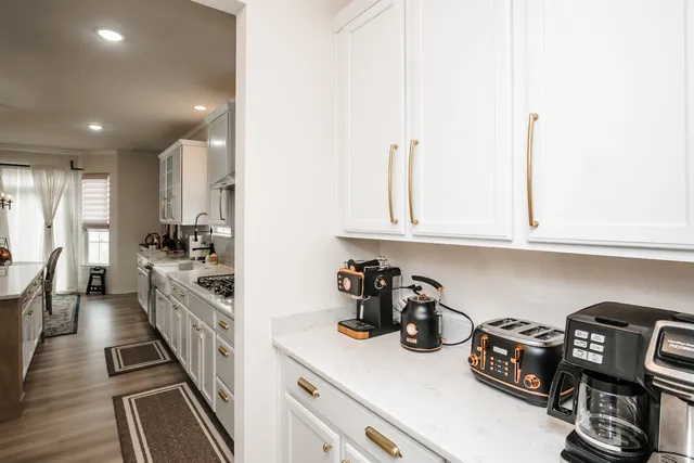 a kitchen with sink refrigerator and stove