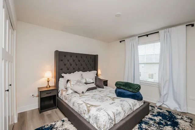 a bedroom with a bed and a window