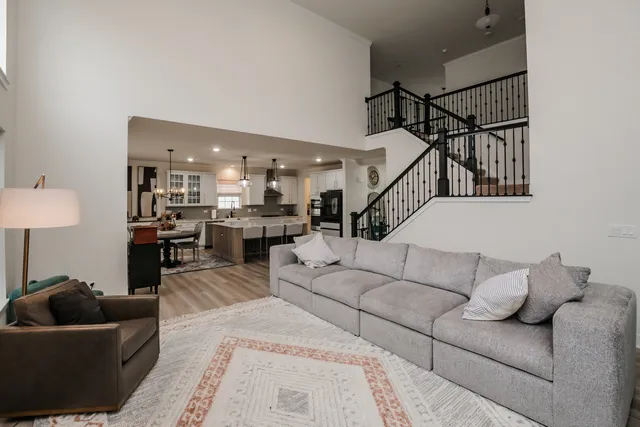a living room with furniture and a ceiling fan