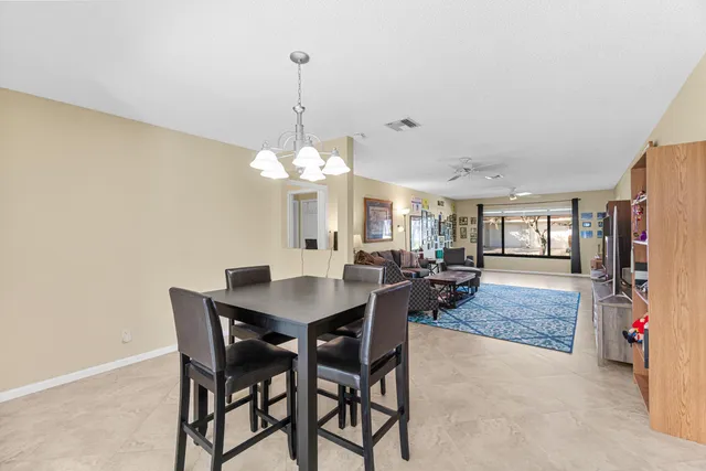 a view of a dining room with furniture and window