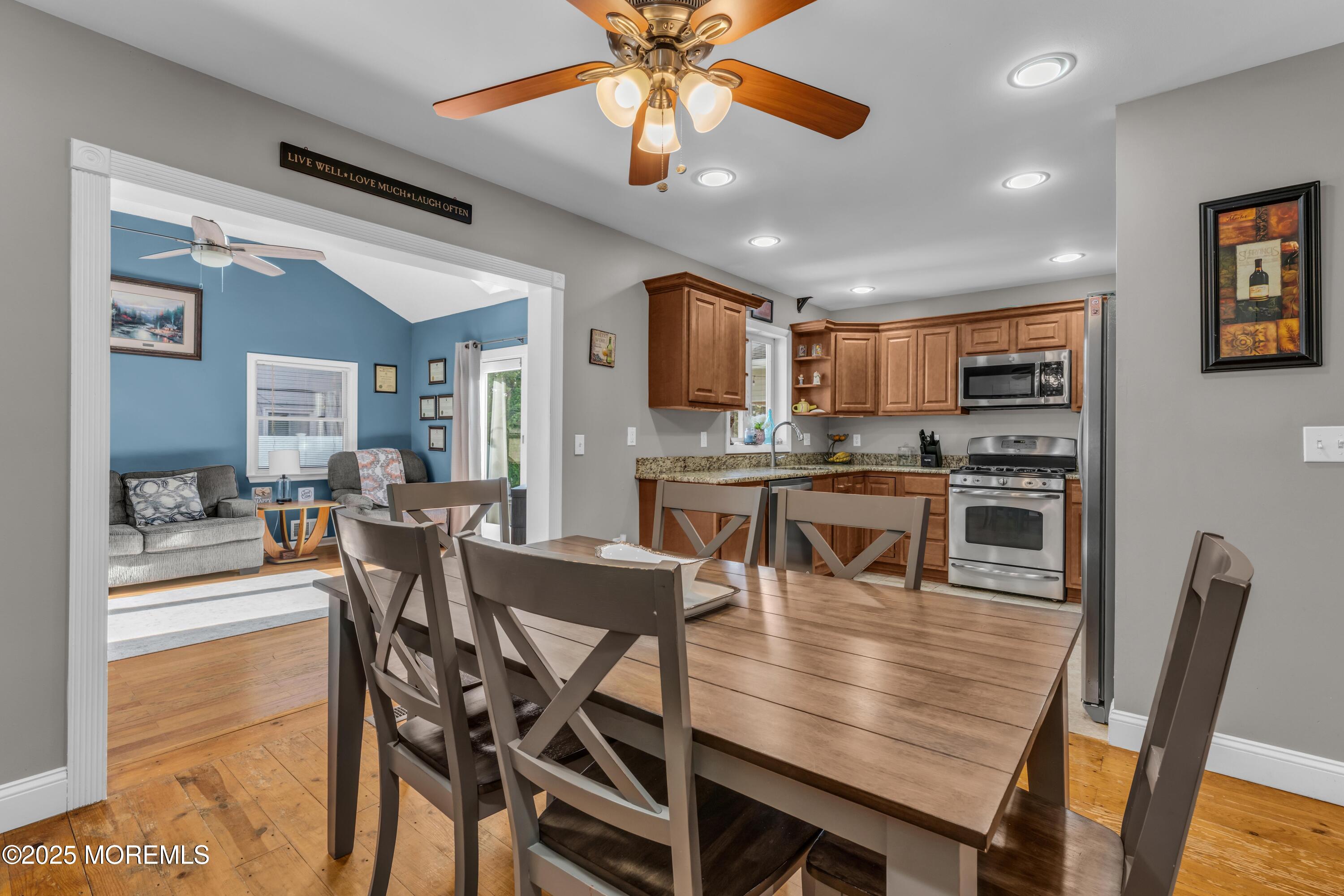 910 Alpine Street Forked River, NJ 08731 - Photo 11 of 32 a dining room with stainless steel appliances kitchen island granite countertop a dining table chairs and a oven