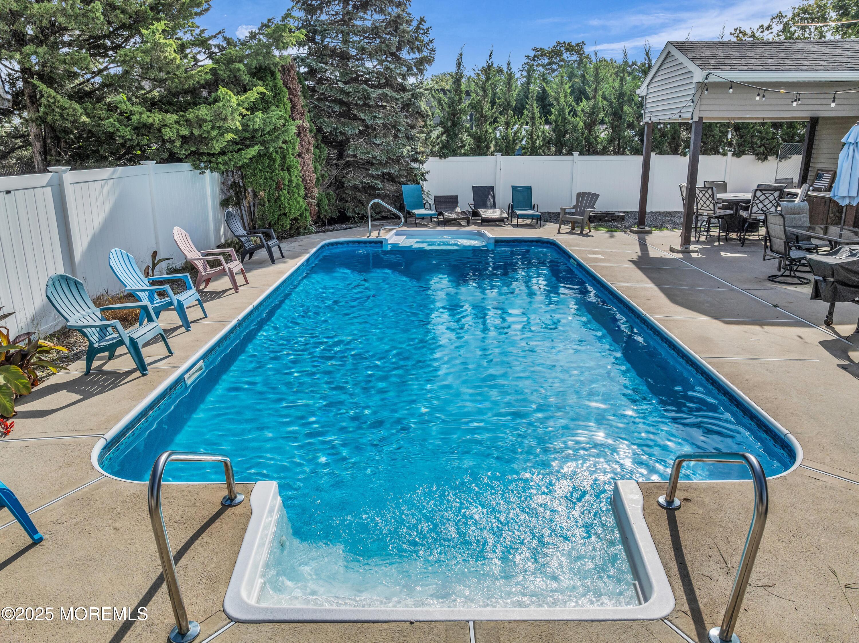 910 Alpine Street Forked River, NJ 08731 - Photo 23 of 32 a swimming pool with outdoor seating